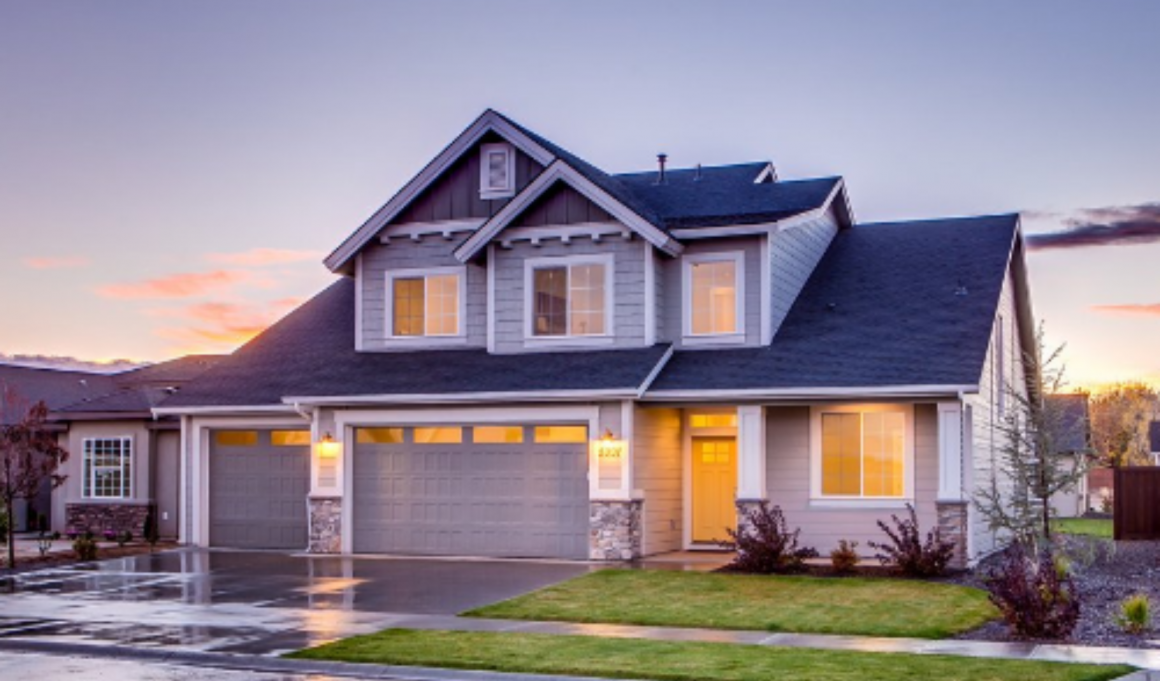 A house with a garage and driveway in front of it.